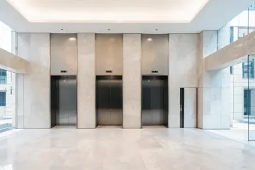Mixed-use podium elevator bank